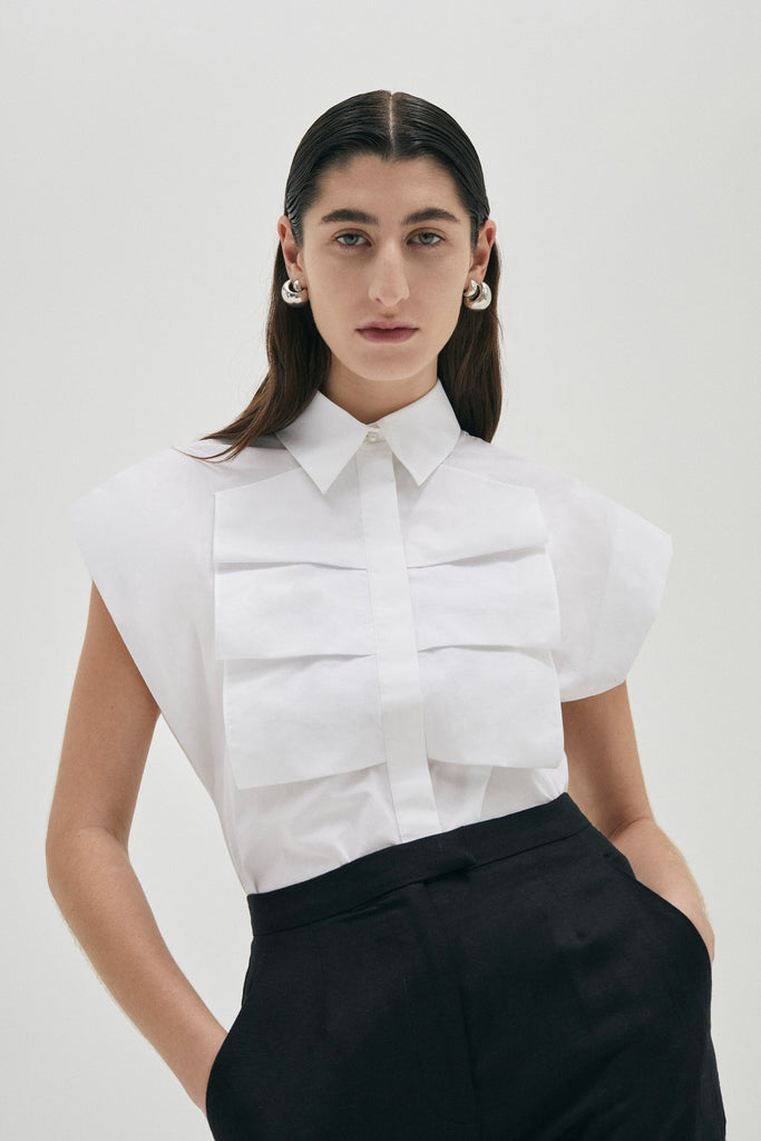 Luxe sleeveless shirt blouse in Cotton from Australian designer PALMA MARTÎN.  Featuring a confident silhouette with wide shoulders, and front ruffle detail. 