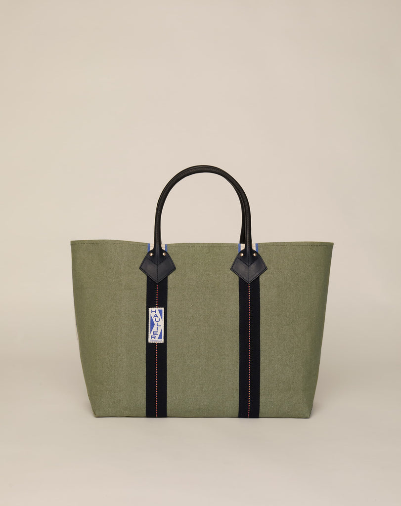 Image of classic canvas tote bag in sage colour with black leather handles and contrasting black stripes.