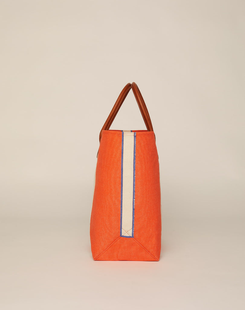 Profile image of medium-sized classic canvas tote bag in orange colour with tan leather handles and contrasting stripes.